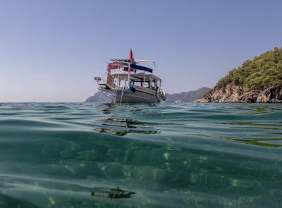 A scenic float trip boat glides gently down a clear mountain river.