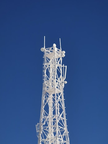 gray metal tower under blue sky
