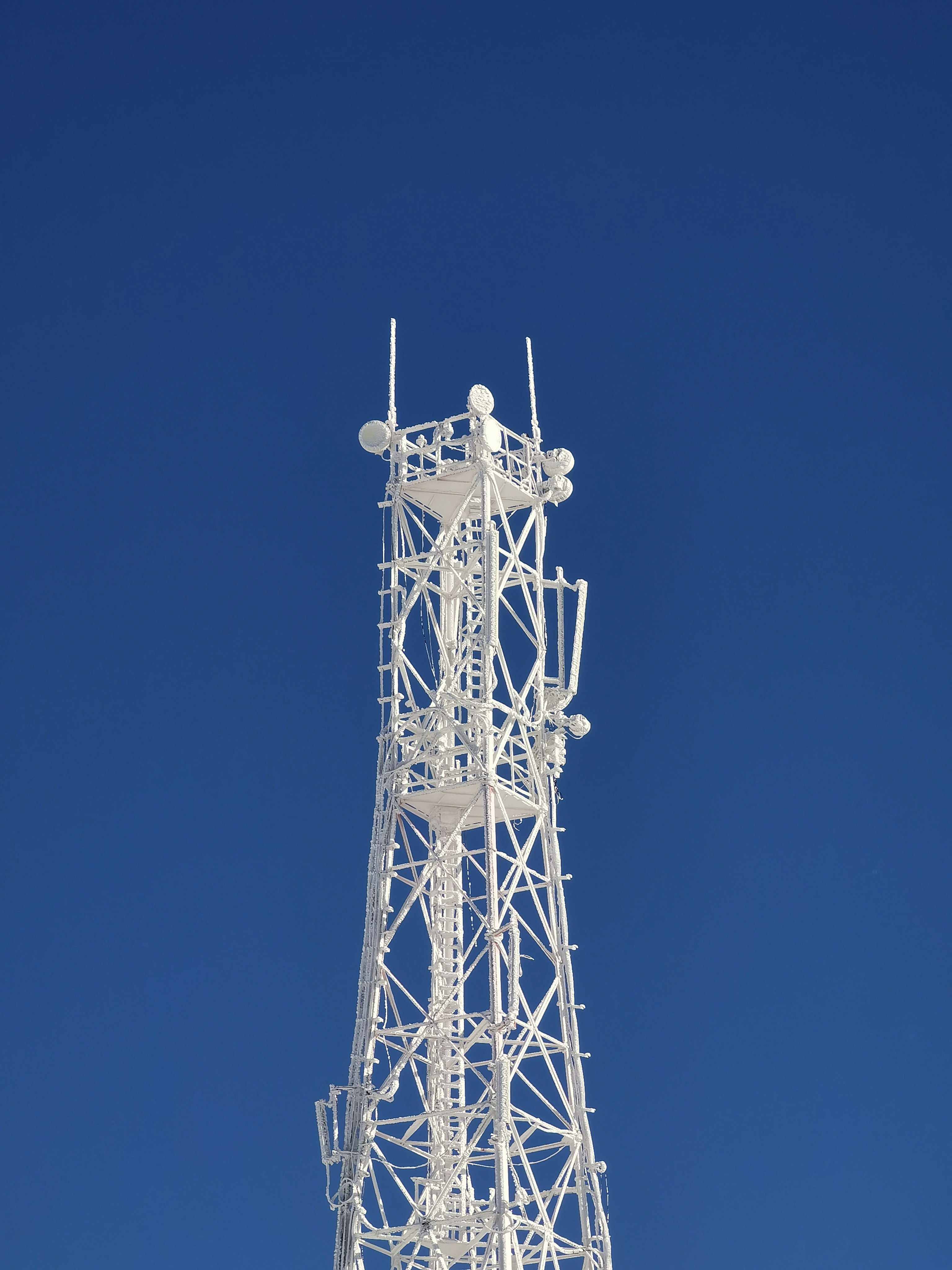 gray metal tower under blue sky