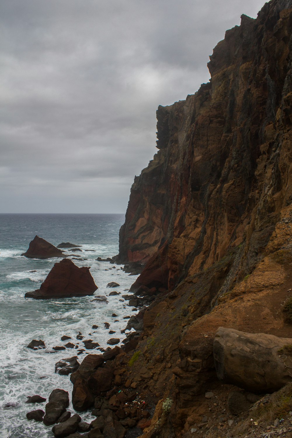 brown rock formation on sea during daytime