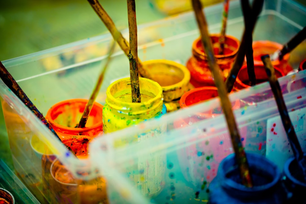 yellow green and red paint cans