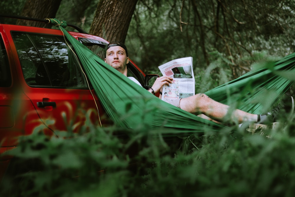 woman in green hammock holding white ceramic mug