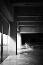 Architects discussing plans over a large table bathed in natural light.