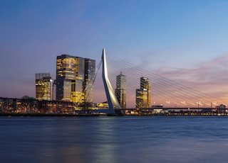 city skyline under blue sky during night time