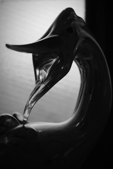 Close-up of a delicate glass figurine reflecting light beautifully