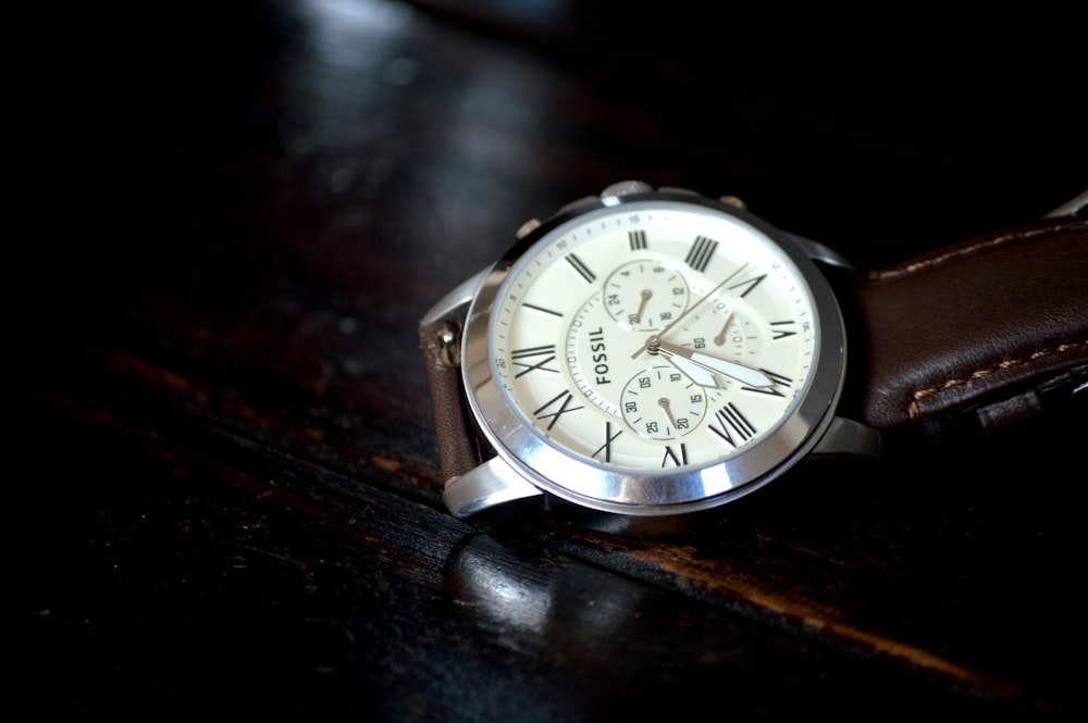silver and white round chronograph watch