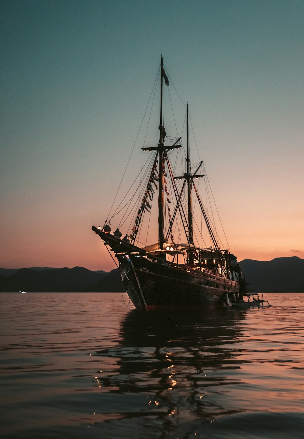 日没時の海の茶色の帆船