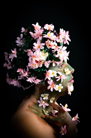 A serene portrait of a woman adorned with natural flowers and tribal face paint, celebrating cultural roots.