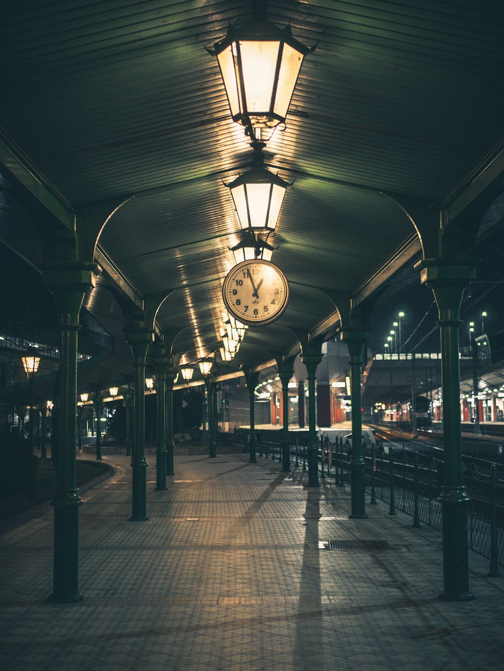 people walking on sidewalk during night time