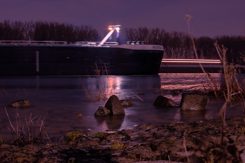 Night view of a cargo ship navigating interior waterways