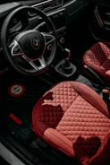 Interior shot of a clean and well-maintained Fiat 500 with summer and winter floor mats.