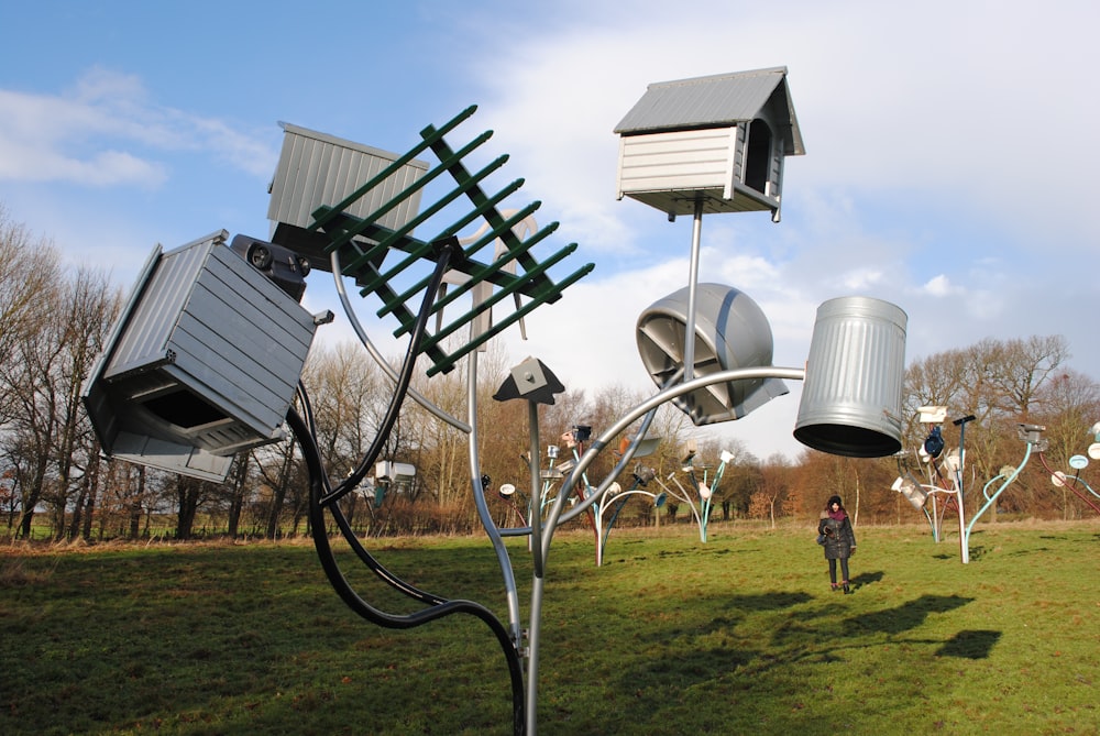 white and gray metal stand on green grass field during daytime