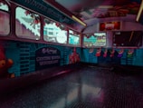 The interior of a bus or vehicle is decorated with vibrant holiday themes, featuring a 'Genting Winter Wonderland' banner. The walls display illustrations of teddy bears, colorful Christmas stockings, and gifts. The windows are adorned with festive garlands, creating a cheerful holiday atmosphere.