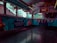 The interior of a bus or vehicle is decorated with vibrant holiday themes, featuring a 'Genting Winter Wonderland' banner. The walls display illustrations of teddy bears, colorful Christmas stockings, and gifts. The windows are adorned with festive garlands, creating a cheerful holiday atmosphere.