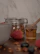 A rustic kitchen scene with honey jars, fresh bread, and a small pot of honey being drizzled.