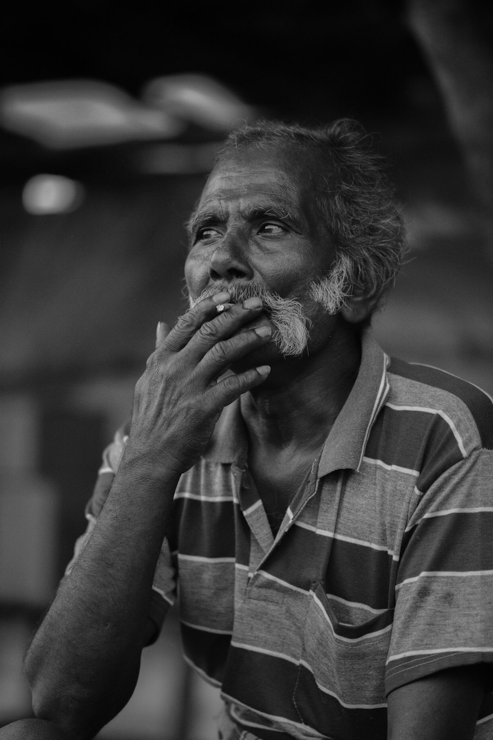 a black and white photo of a man with a mustache