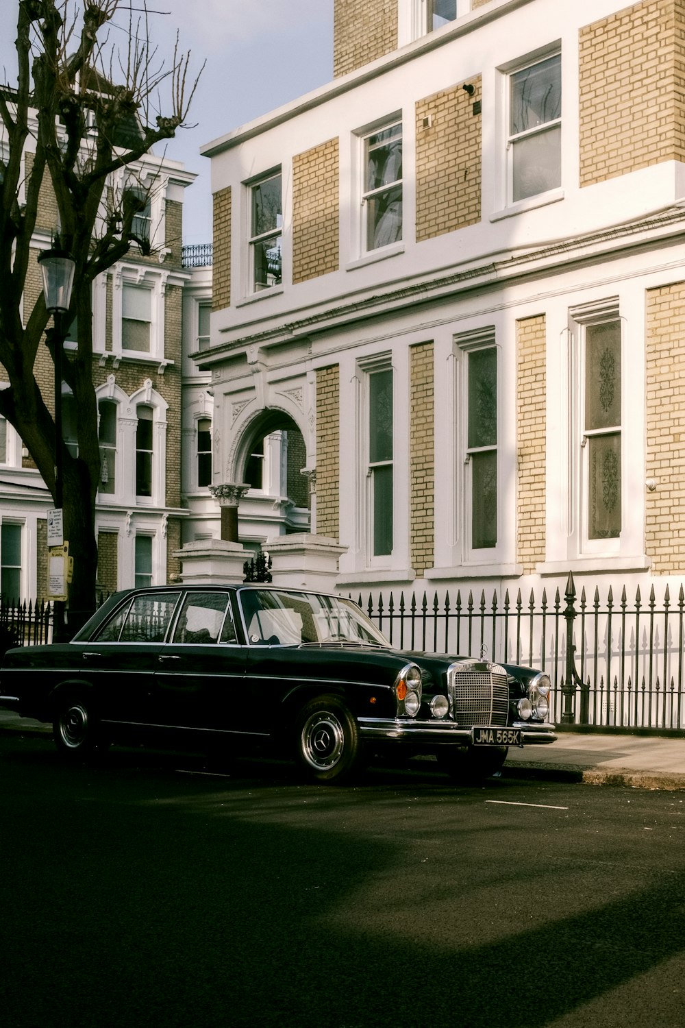 black car parked in front of white building