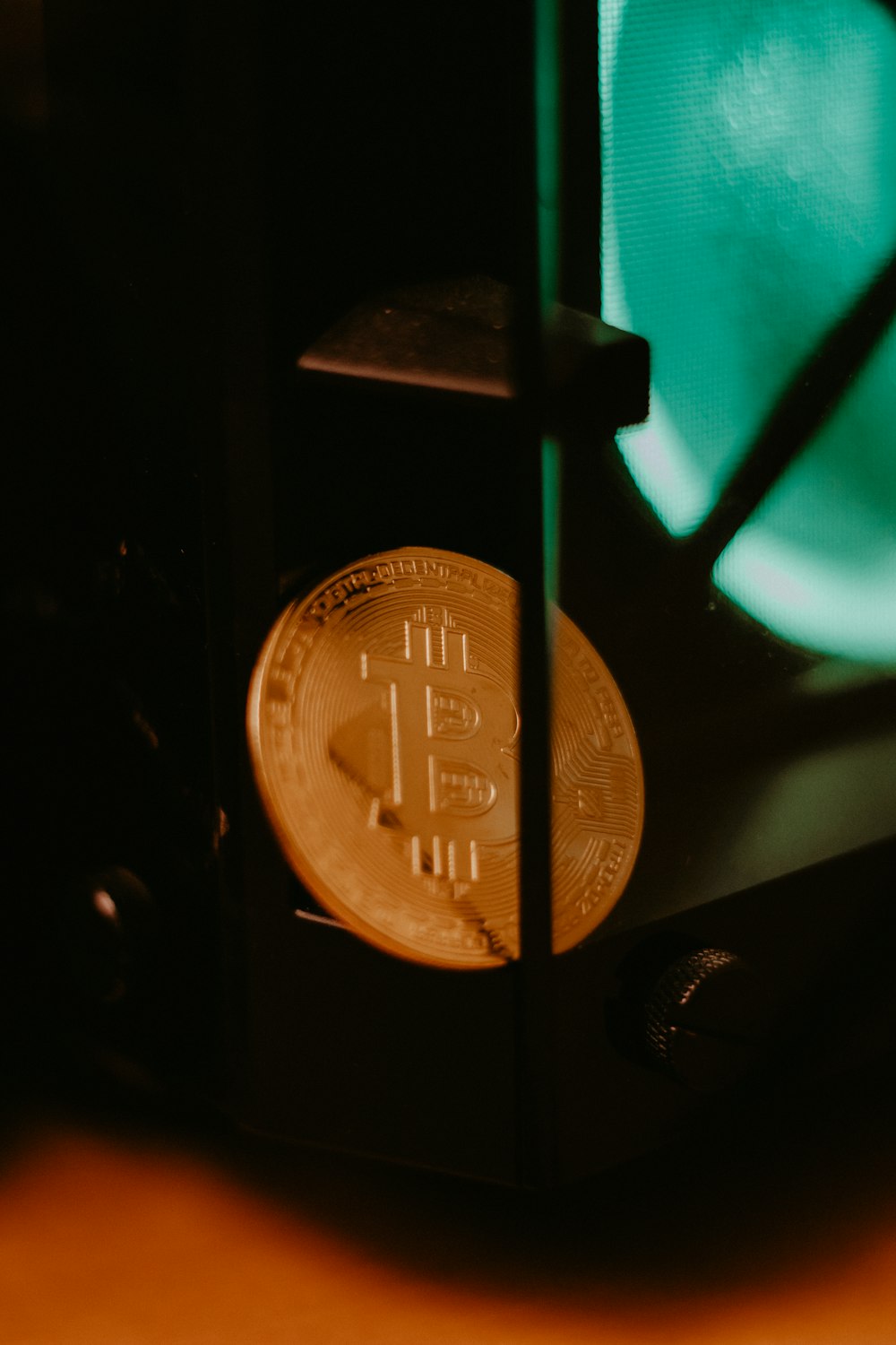 gold round coin on black surface