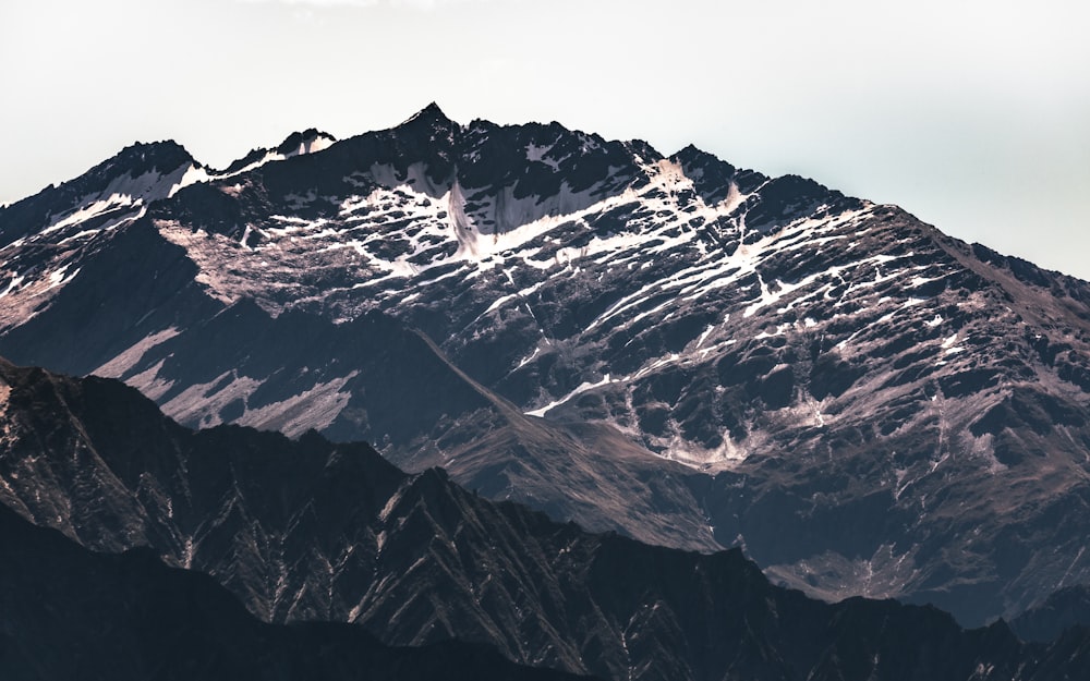 snow covered mountain under cloudy sky during daytime