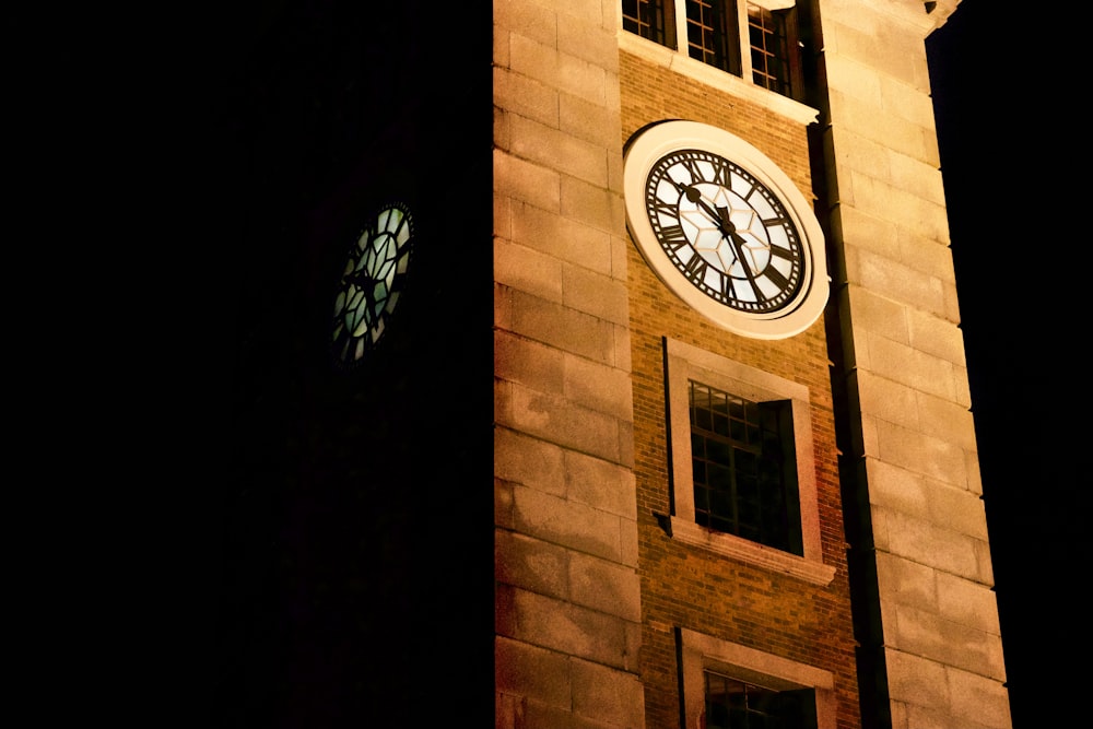 brown brick building with analog clock