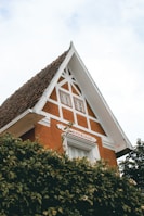House featuring a freshly renovated pitched roof with neat rows of terracotta tiles.