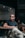 man in black polo shirt wearing black sunglasses sitting on chair