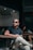 man in black polo shirt wearing black sunglasses sitting on chair