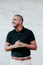 A friendly customer service representative wearing a sporty black and white outfit, smiling and ready to assist.