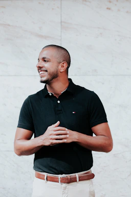 A friendly customer service representative wearing a sporty black and white outfit, smiling and ready to assist.