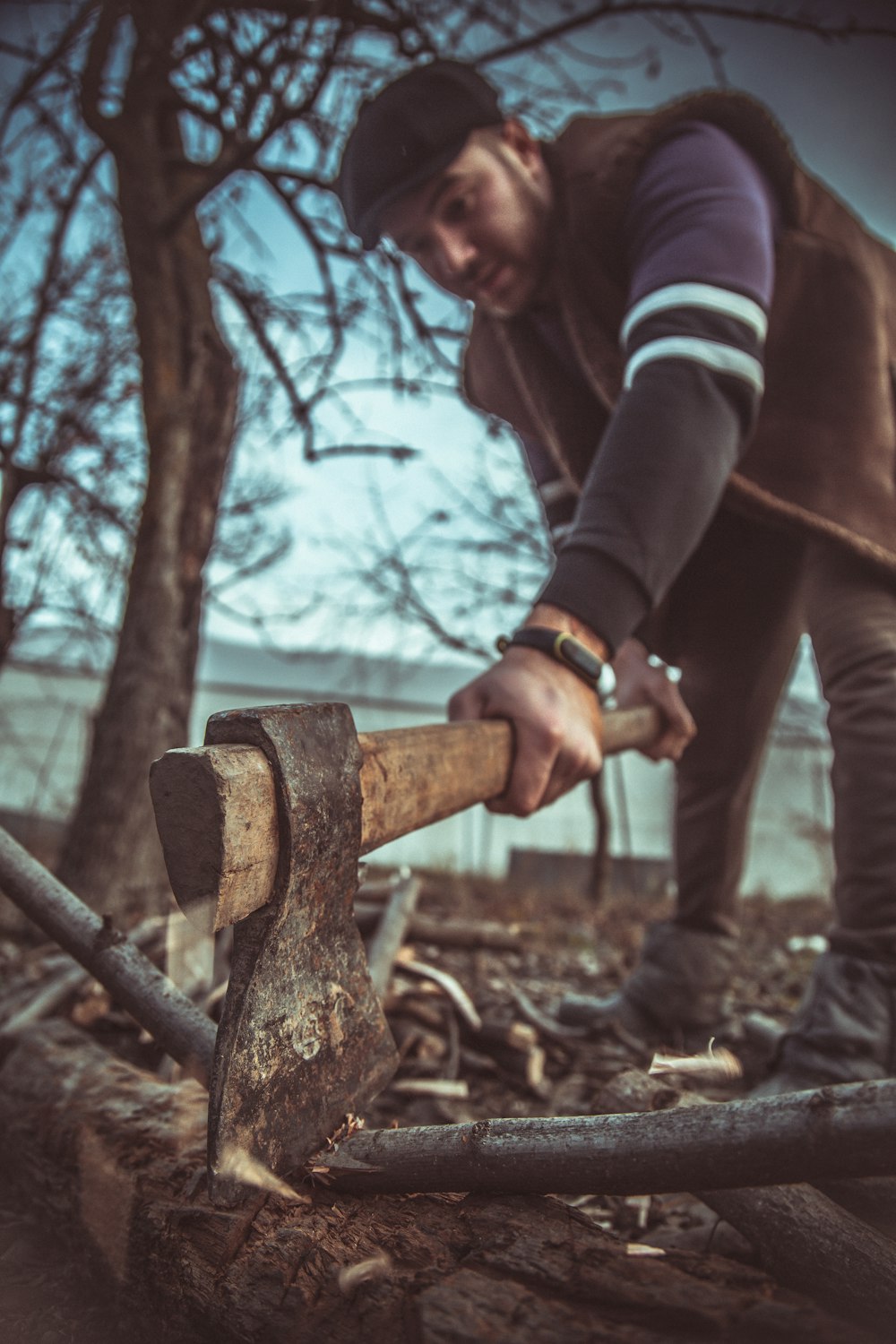 person holding brown and black axe