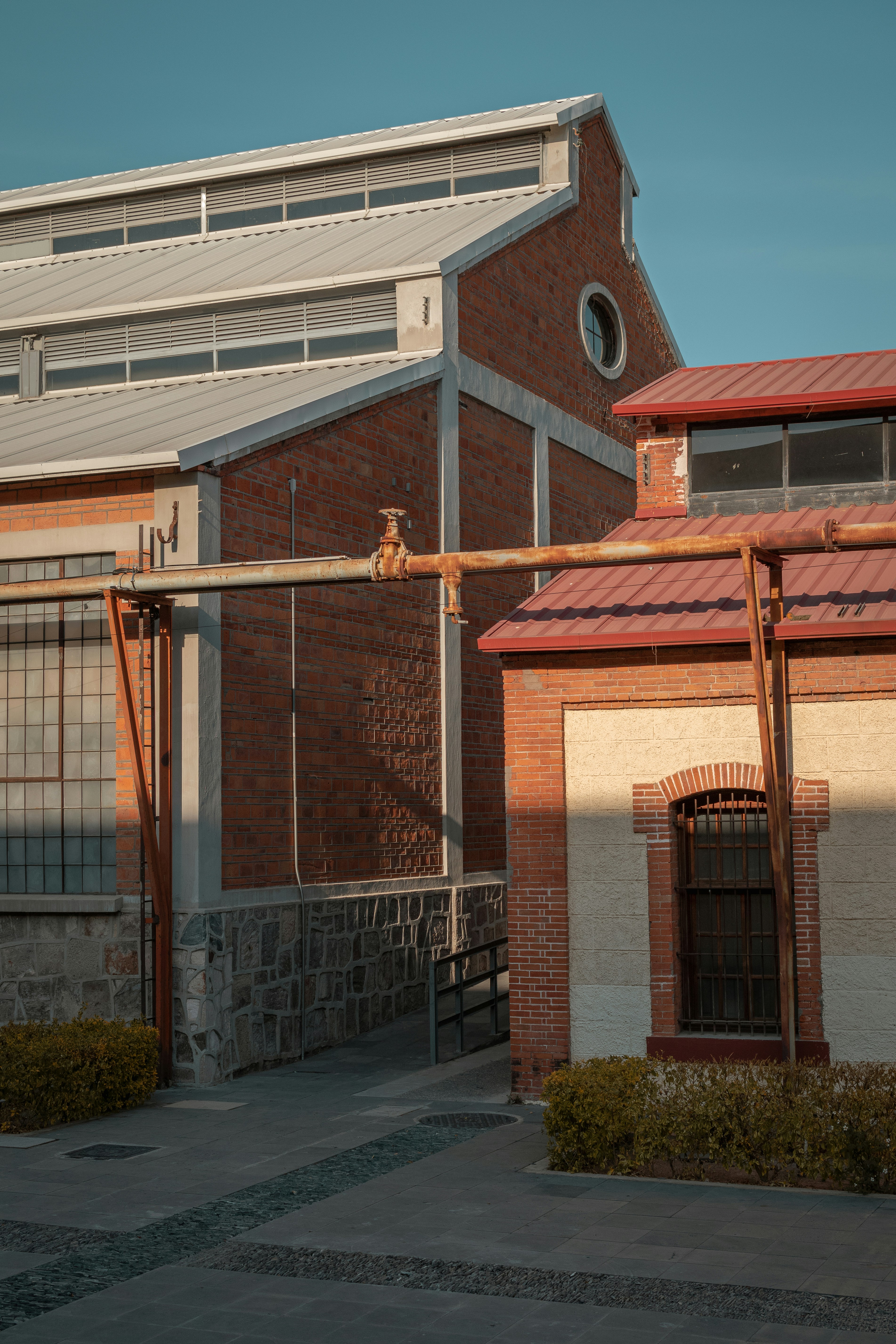 brown brick house with white metal window frame