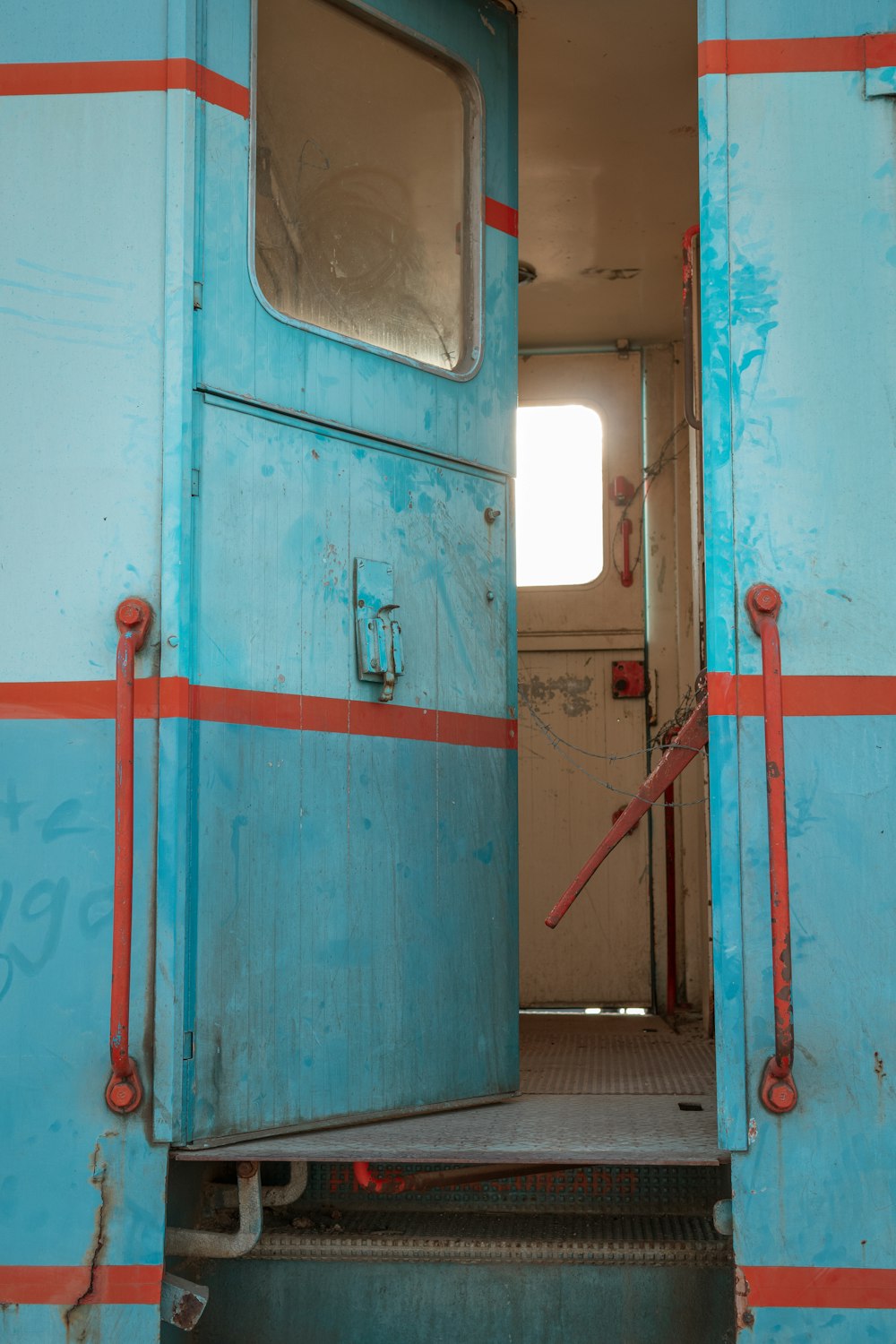 red metal pipe on blue wall