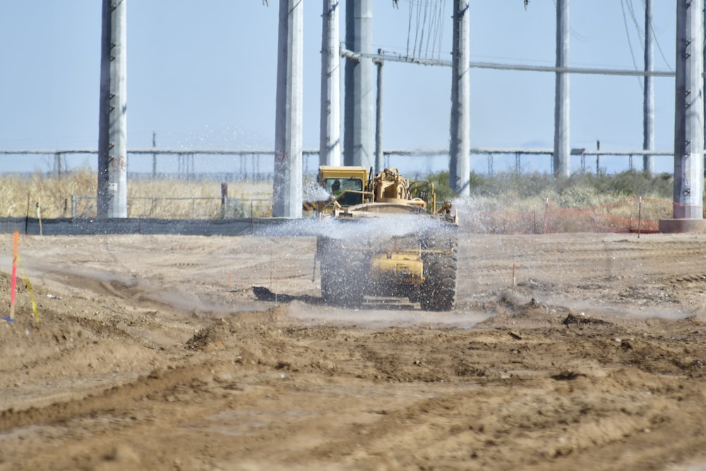 yellow heavy equipment on brown soil