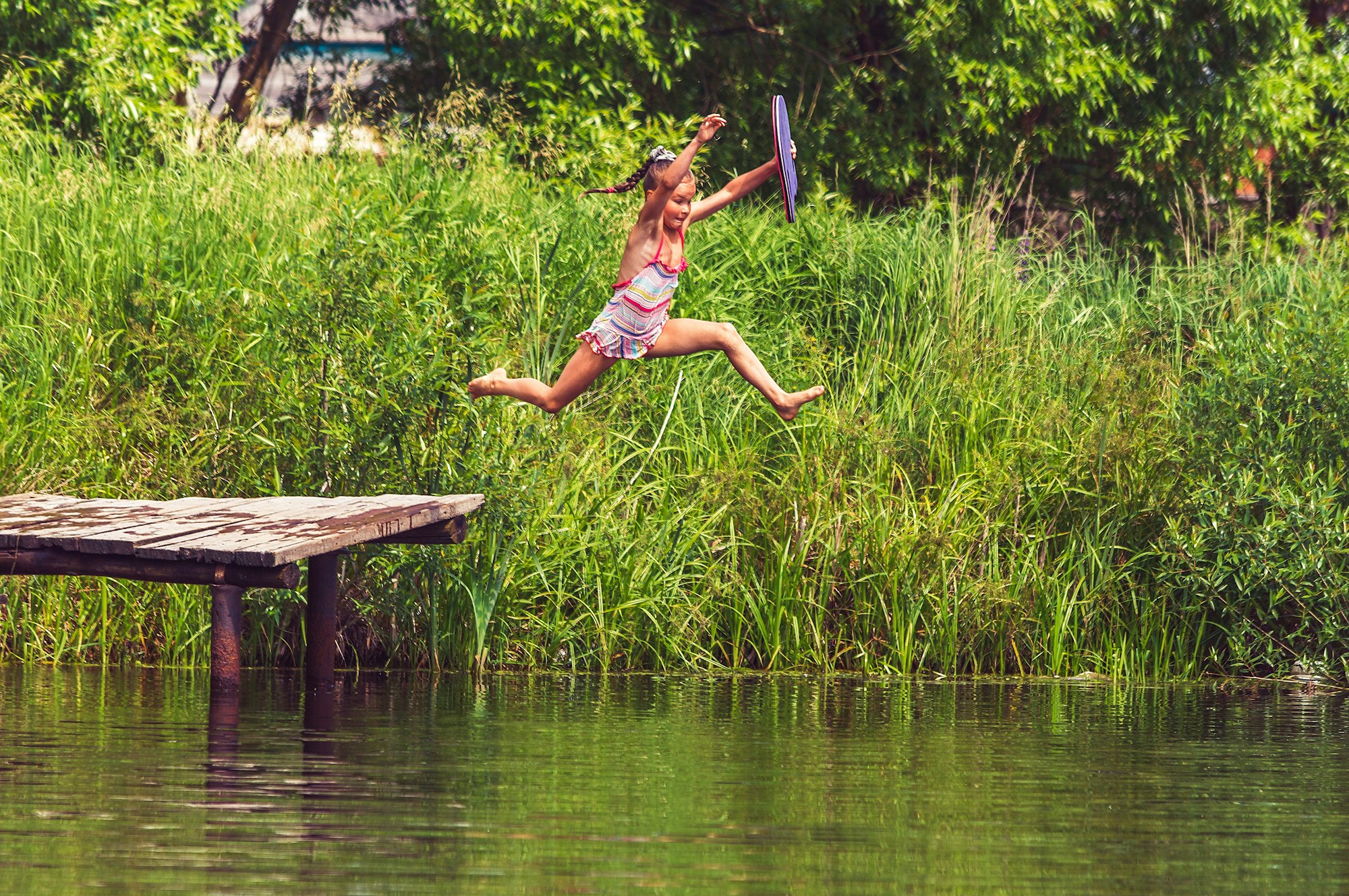 the girl happily jumping into the water