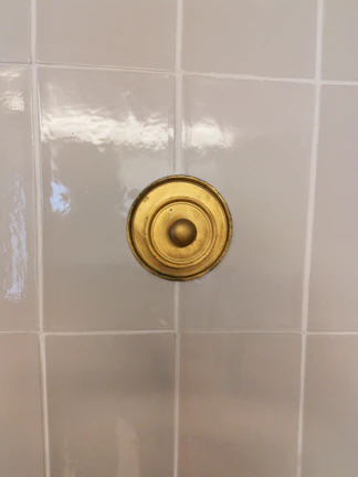 Close-up of freshly tiled bathroom walls with modern fixtures installed.