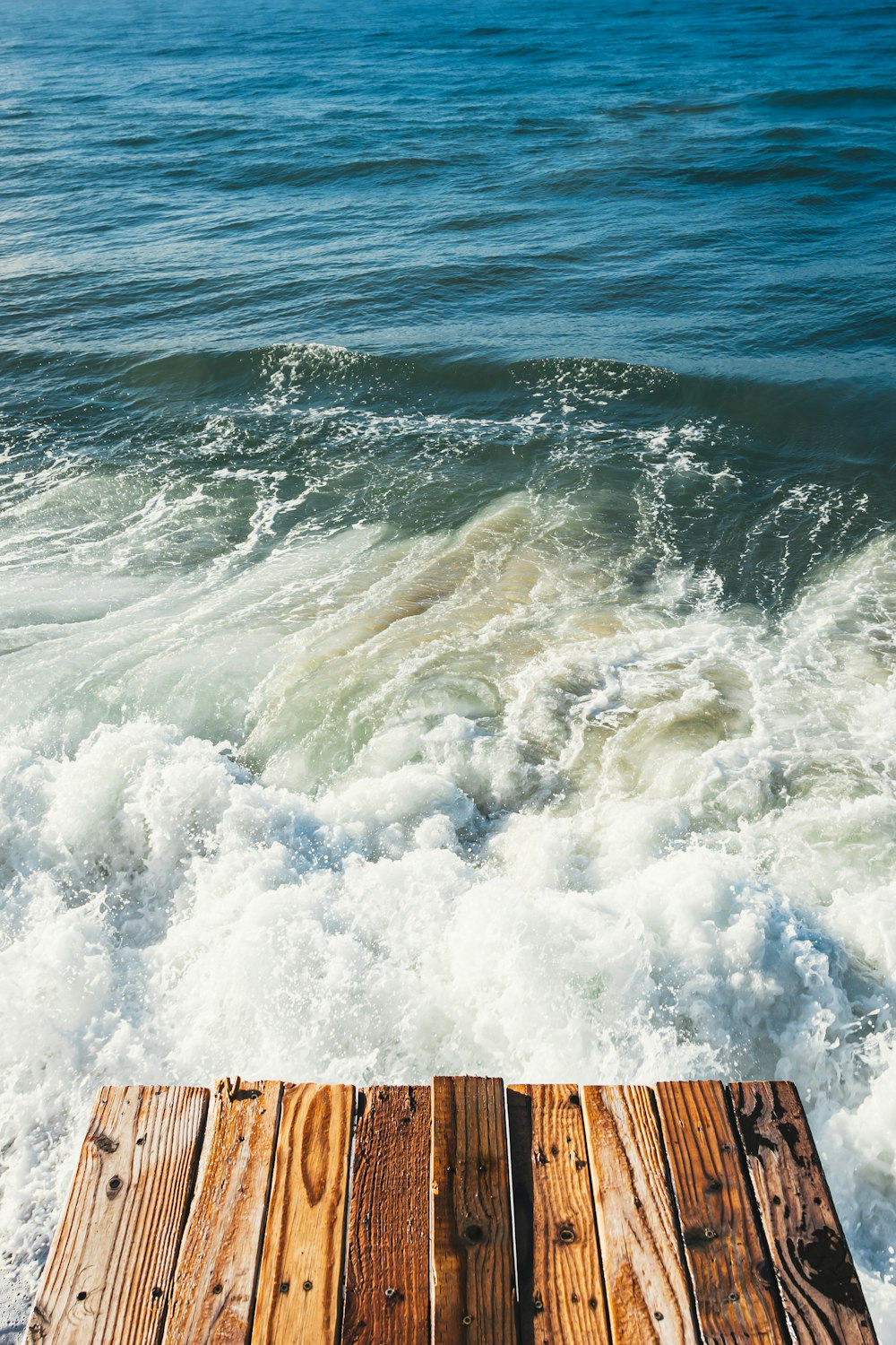 Muelle de madera marrón en el mar durante el día