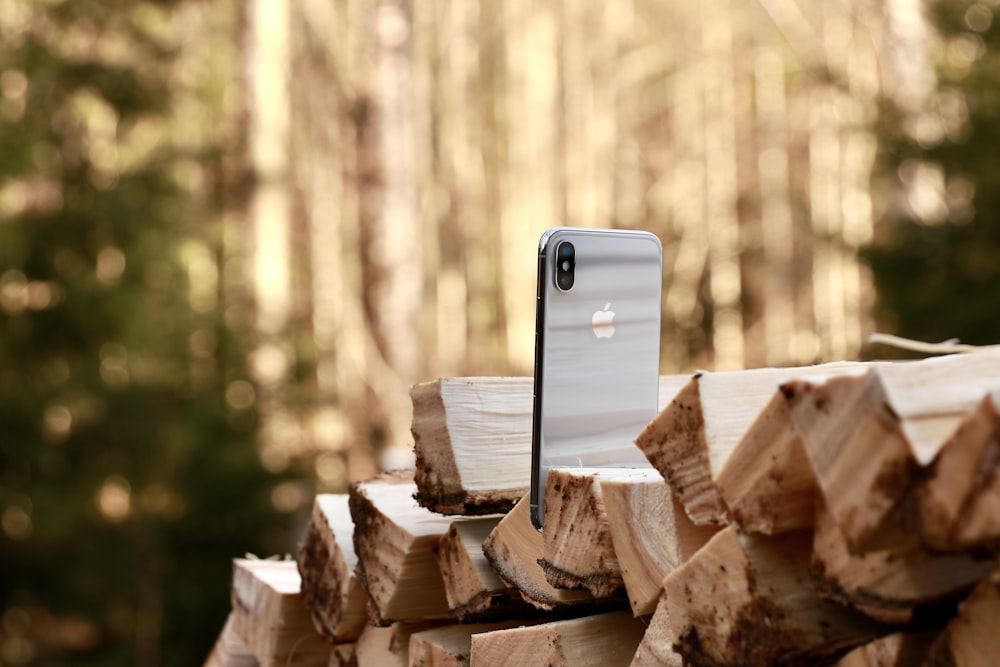 white iphone 5 c on brown wooden log