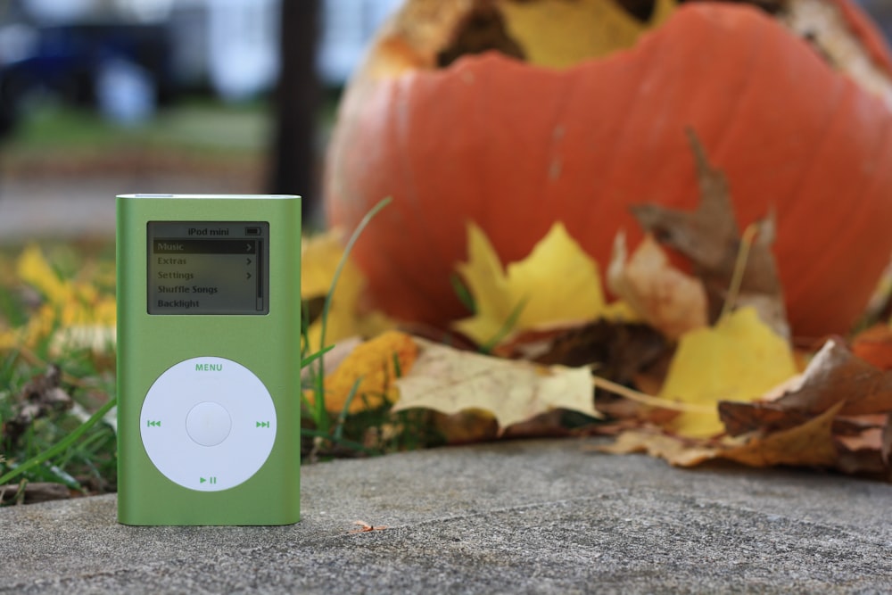 white ipod nano 4 th generation on gray concrete floor