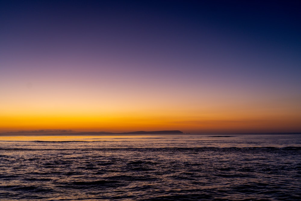 body of water during sunset