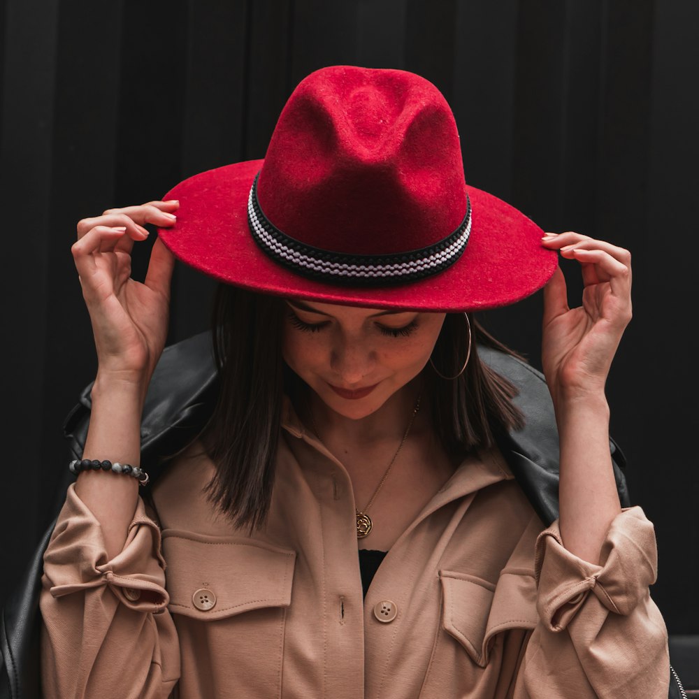 woman in brown coat wearing red hat