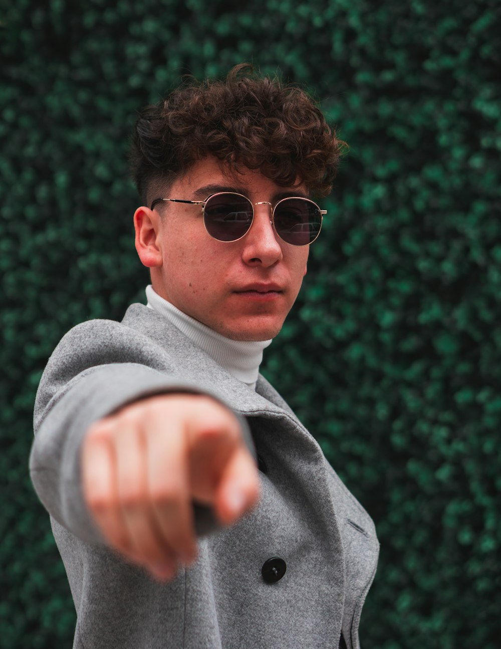 man in gray sweater wearing black sunglasses