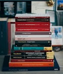 red and white books on brown wooden table