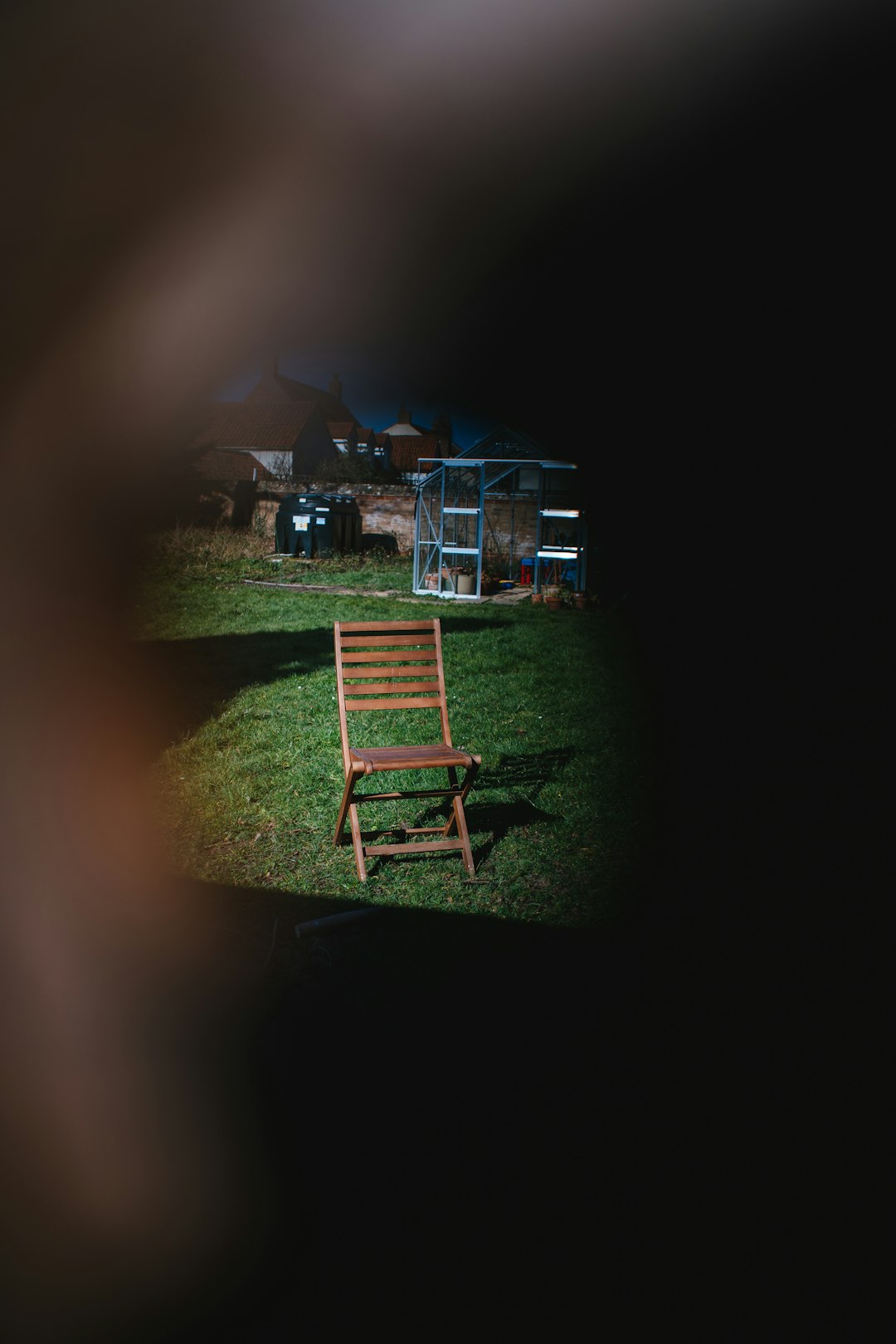 brown wooden folding chair on green grass field during night time