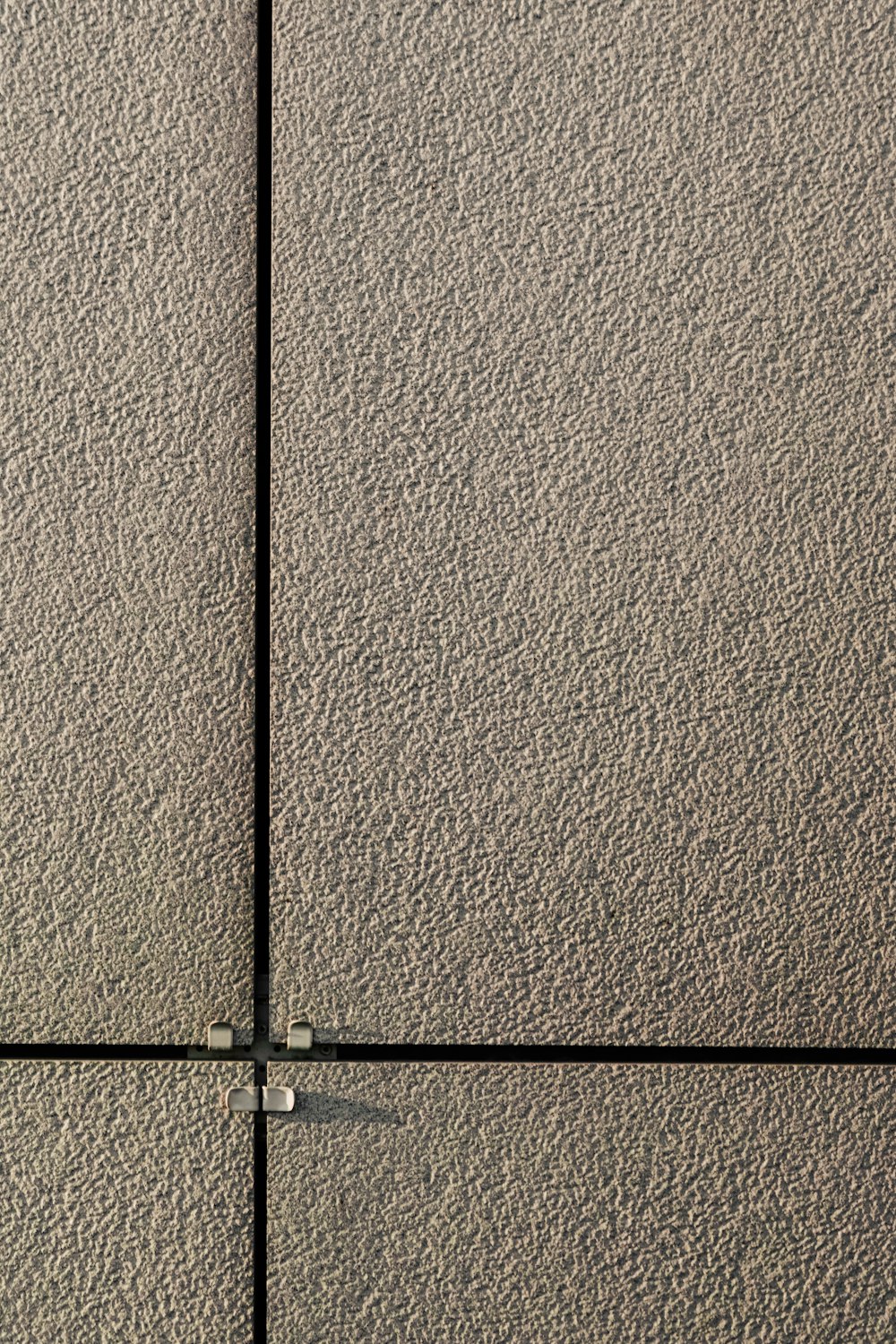 black metal rod on brown concrete wall