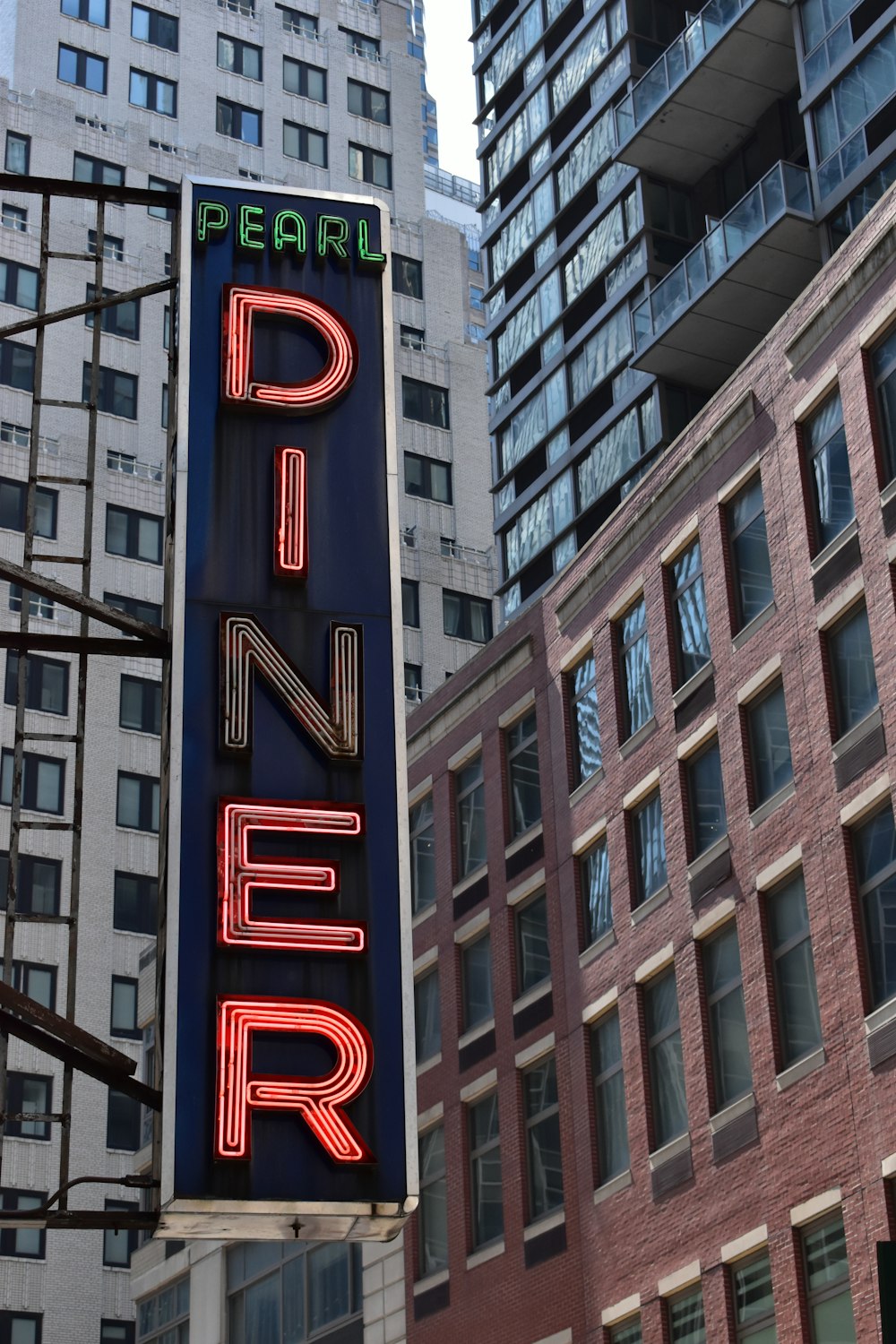 a large neon sign hanging from the side of a building