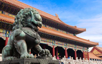 A bronze guardian lion statue before the Hall of Supreme Harmony in Beijing, China