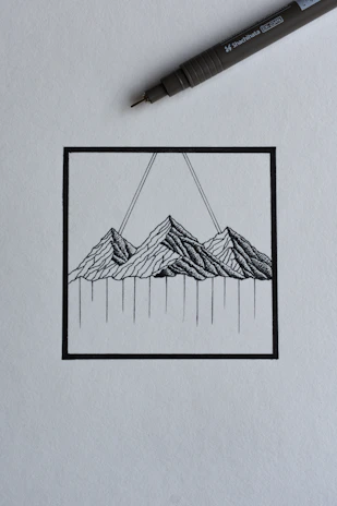 A minimalist fine-line tattoo of a mountain range on the forearm, delicate and precise.
