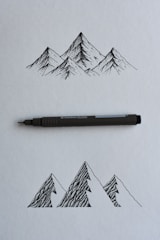 black and gray click pen on white printer paper