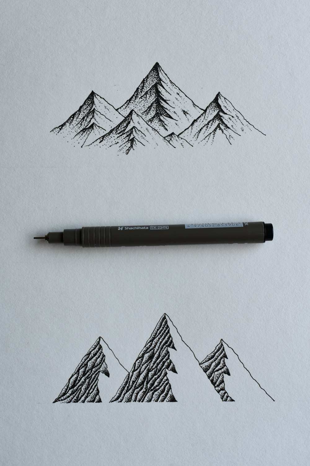 black and gray click pen on white printer paper