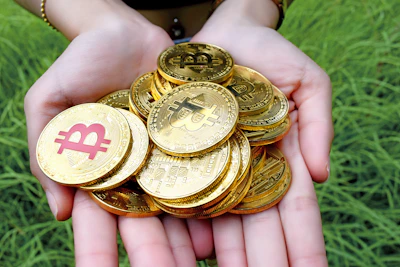Close-up of a hand holding a growing stack of coins symbolizing high returns.